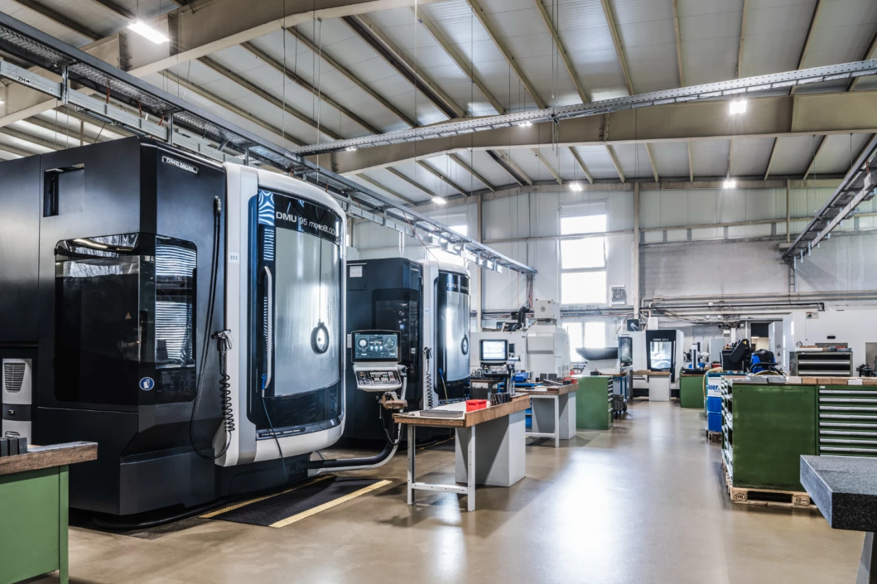 Blick in die Produktionshalle von hepro production ag mit mehreren CNC-Bearbeitungszentren, aufgeräumten Arbeitsplätzen und moderner Fertigungsinfrastruktur.